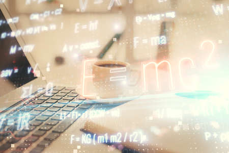 Double exposure of formula drawing and desktop with coffee and items on table background. Concept of...