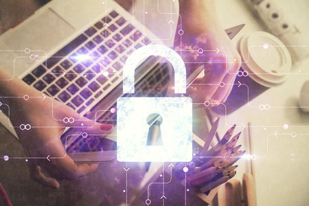 Double exposure of woman hands working on computer and lock hologram drawing. Security concept.