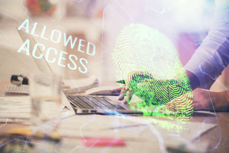 Double exposure of woman hands typing on computer and fingerprint drawing. Security concept.