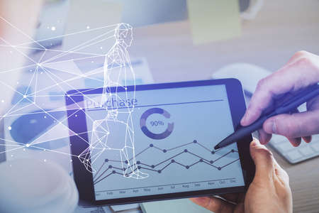 Double exposure of man's hands holding and using a mobile device and creative hologram drawing.