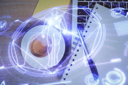 Education hologram drawings over computer on the desktop tableの写真素材