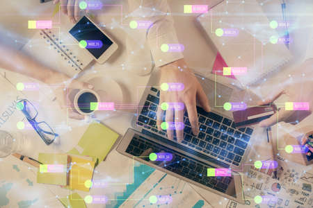 Double exposure of man's hands typing over computer keyboard and data theme hologram drawing.の写真素材