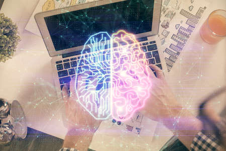 Double exposure of man's hands typing over computer keyboard and brain hologram drawing.の写真素材