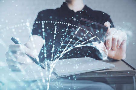 Double exposure of man hands holding a credit card and DNA drawing. On-line Education and E-commerce concept.の写真素材
