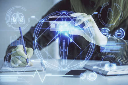 Multi exposure of woman on-line shopping holding a credit card and education theme drawing. E-learning concept.の写真素材