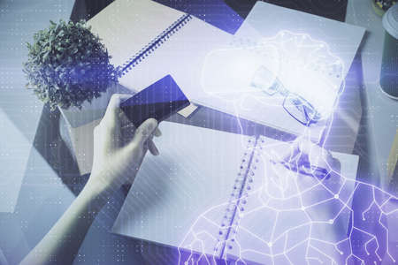 Multi exposure of woman on-line shopping holding a credit card and man in AR glasses drawing. E-learning concept.の写真素材