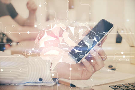 Double exposure of man's hand holding and using a digital device and brain hologram drawing. Data concept.の写真素材
