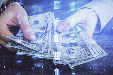 Multi exposure of technology drawing hologram and us dollars bills and man hands. Data conceptの写真素材