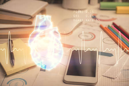 Double exposure of human heart drawing and cell phone background. Concept of medical education