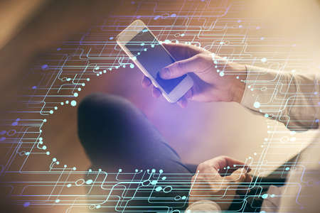 Double exposure of man's hand holding and using a digital device and data theme drawing. Technology...