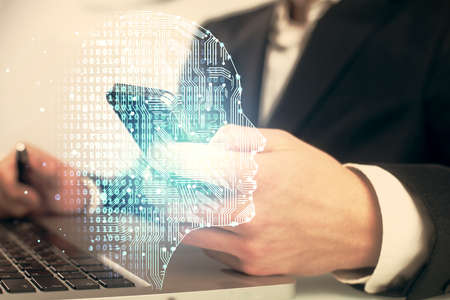 Double exposure of man's hand holding and using a digital device and brain hologram drawing. Data...