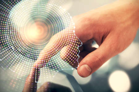 Double exposure of man's hand holding and using a digital device and brain hologram drawing. Data...