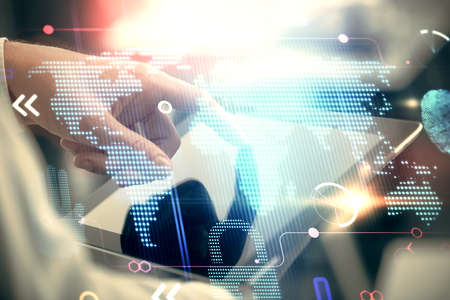 Multi exposure of man's hands holding and using a digital device and map drawing. International...