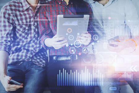 Double exposure of data theme hologram drawing and man and woman working together holding and using...