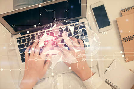 Double exposure of woman working on computer andhuman brain hologram drawing. Top View. Ai concept.