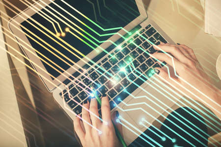 Double exposure of woman hands working on computer and data theme hologram drawing. Top View. Technology concept.の写真素材