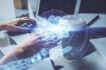 Double exposure of woman hands working on computer and data theme hologram drawing. Tech concept.