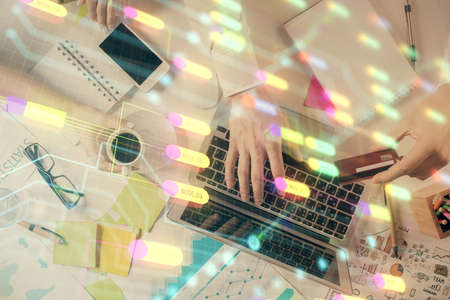 Double exposure of man's hands typing over computer keyboard and data theme hologram drawing. Top...