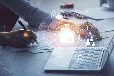 Double exposure of woman hands typing on computer and buildings drawing. Smart-city concept.の写真素材