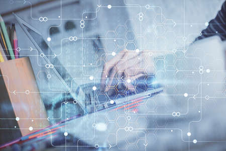 Double exposure of woman hands working on computer and data theme hologram drawing. Tech concept.