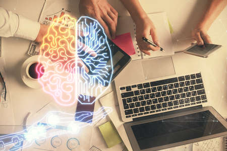 Double exposure of man and woman working together and human brain hologram drawing. Brainstorm concept. Computer background. Top View.の写真素材