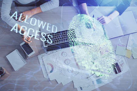 Double exposure of woman hands working on computer and fingerprint hologram drawing. Top View....