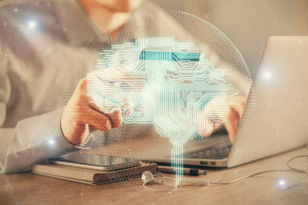 Double exposure of man hands typing on computer with credit card and brain theme drawing. E-commerce...
