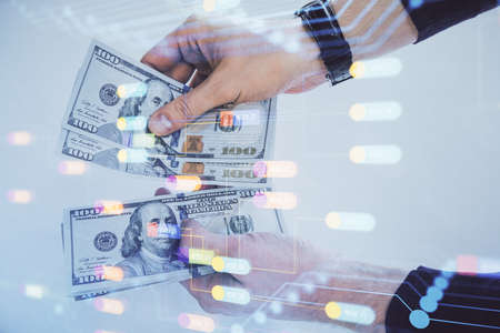 Multi exposure of technology drawing hologram and us dollars bills and man hands. Data conceptの写真素材