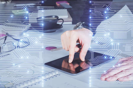 Double exposure of man's hands holding and using a digital device and tech theme hologram drawing....