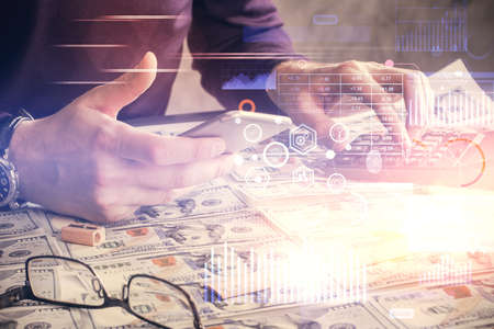 Multi exposure of man's hand holding and using a digital device and data theme drawing. Innovation...