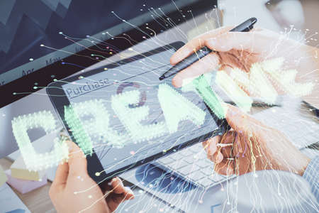 Double exposure of man's hands holding and using a mobile device and creative hologram drawing.の写真素材