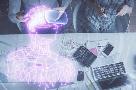 Double exposure of man and woman working together and man in virtual glasses hologram drawing. Computer background. Top View. VR, AR concept.の写真素材