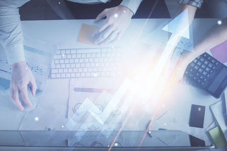Double exposure of man and woman working together and arrows drawing. Computer background. Top View....