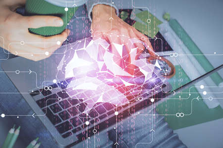 Double exposure of woman hands working on computer and brain hologram drawing. Ai concept.
