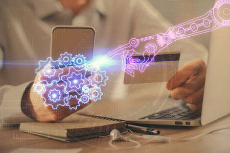 Double exposure of man hands holding a credit card and data theme drawing. E-commerce and technology...