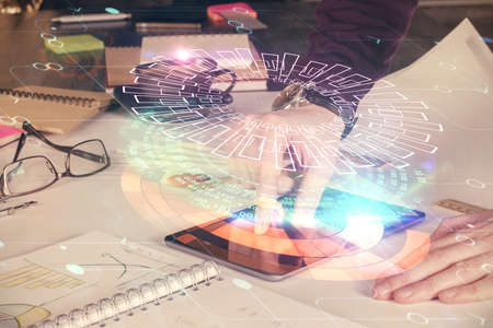 Double exposure of man's hand holding and using a digital device and data theme drawing. Technology...