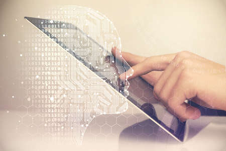 Double exposure of man's hand holding and using a digital device and brain hologram drawing. Data...
