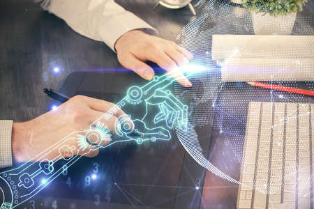 Double exposure of man's hands holding and using a digital device and tech theme hologram drawing....
