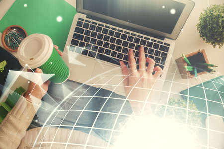 Double exposure of woman hands working on computer and world map hologram drawing. Top View....
