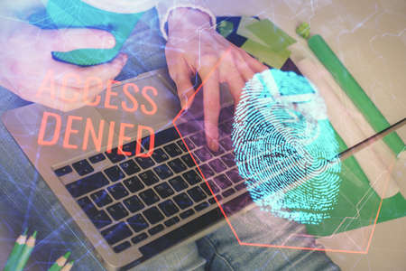 Double exposure of woman hands typing on computer and fingerprint drawing. Security concept.