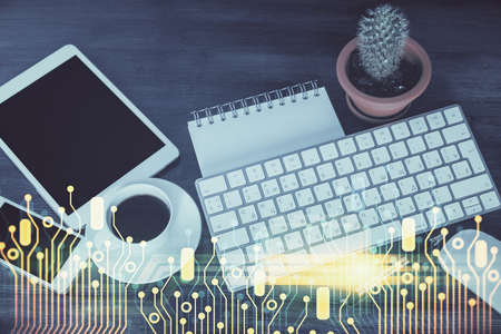 Double exposure of technology theme drawing over work table desktop. Top view. Global data analysis...