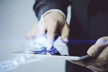 Double exposure of man's hands holding and using a mobile device and creative hologram drawing.の写真素材