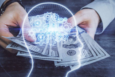 Multi exposure of brain drawing hologram and us dollars bills and man hands. Ai invest concept