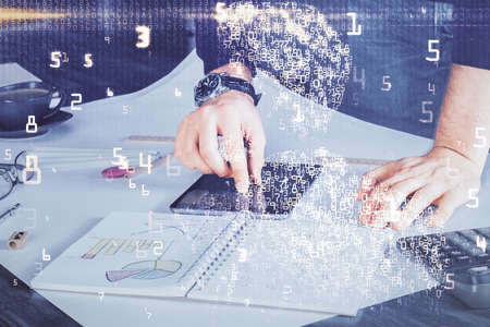 Double exposure of man's hands holding and using a digital device and tech theme hologram drawing....