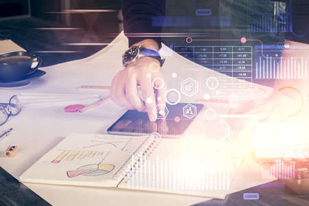 Double exposure of man's hand holding and using a digital device and data theme drawing. Technology...