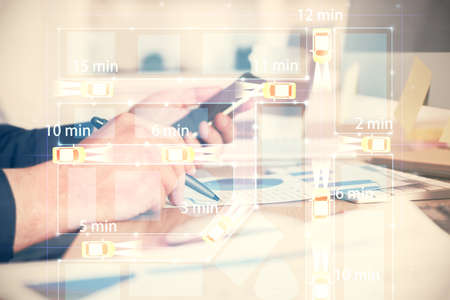 Double exposure of man's hands holding and using a digital device and automobile theme hologram drawing. Technology concept.の写真素材