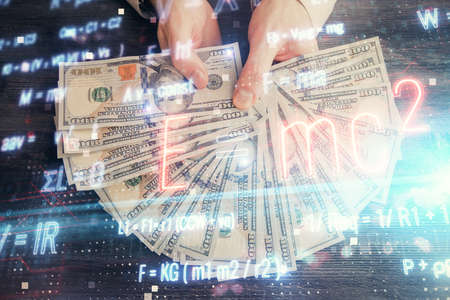 Multi exposure of Formulas drawing hologram and USA dollars bills and man hands. Educationの写真素材