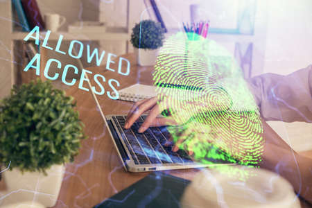 Double exposure of woman hands typing on computer and fingerprint drawing. Security concept.