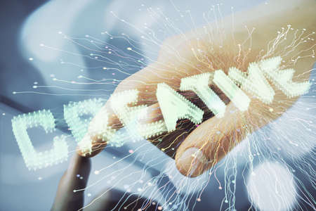Double exposure of man's hands holding and using a mobile device and creative hologram drawing.の写真素材