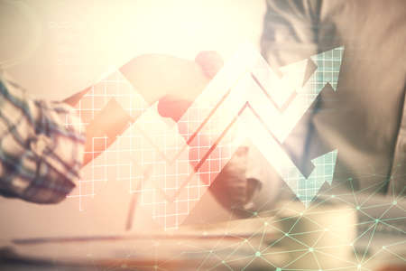 Double exposure of arrows drawings hologram and handshake of two men. Success concept.